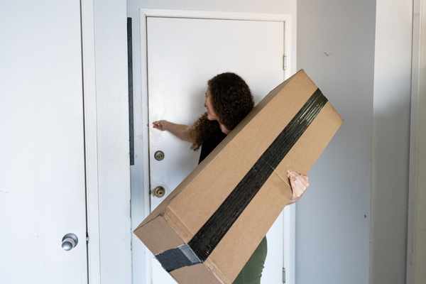 iStock Credit: Boogich A woman holding a box